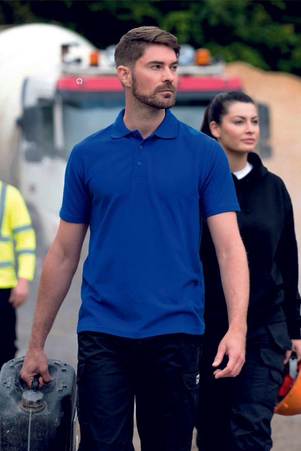 Four individuals walking outdoors with construction equipment, featuring the Pro RTX logo.